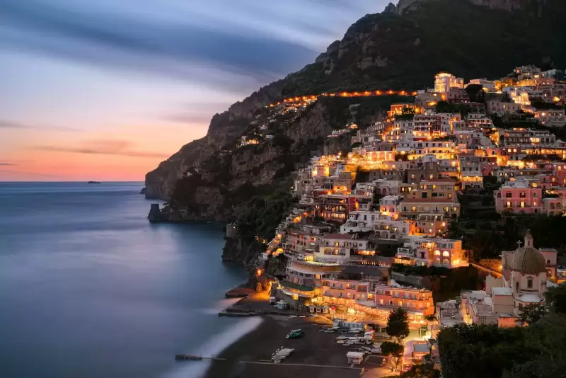 Làng Positano bám sườn đồi thắp đèn về đêm bên bờ biển Amalfi