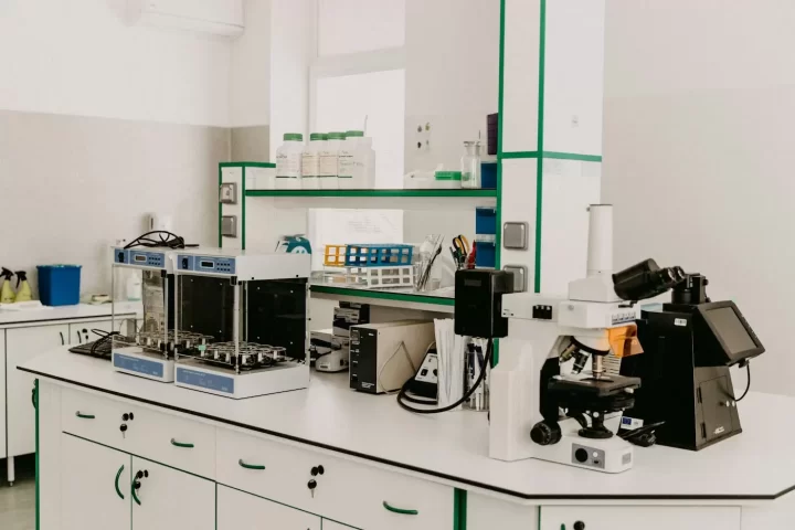 Bàn thí nghiệm với kính hiển vi và thiết bị phân tích trong phòng sáng