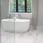 Bồn tắm đứng màu trắng cạnh cửa sổ lớn tại phòng Mây của homestay Đồi Thông Mây Đà Lạt