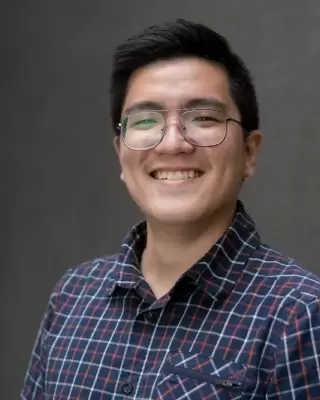 Bố bé đeo kính, áo sơ mi caro, cười tươi trên nền tối